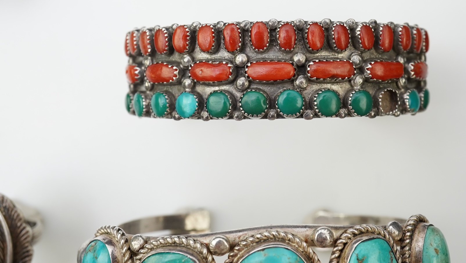 A collection of silver jewellery including a Zuni bangle
